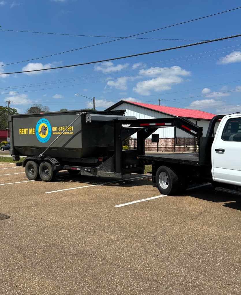Branded Mid South dumpster trailer closeup with logo and phone number