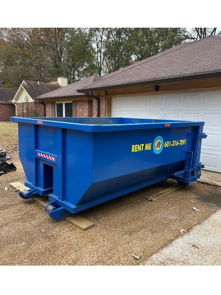 Roll-off construction dumpster rental at a job site in Pearl, Mississippi
