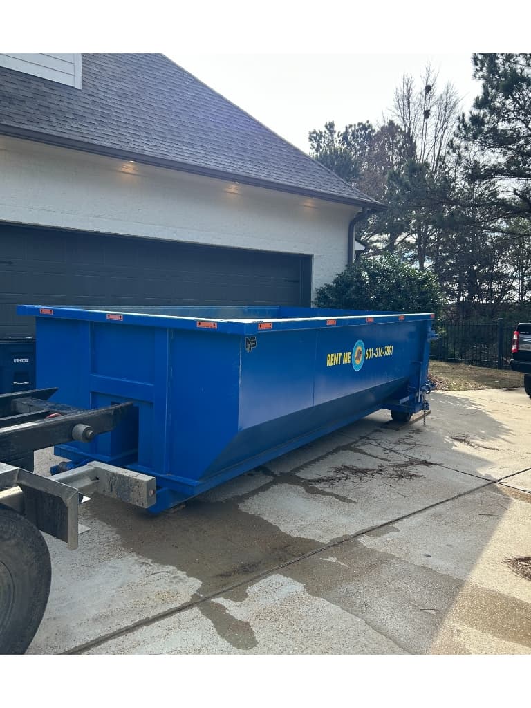 Clean 20-yard roll off dumpster rental delivery in a Madison, MS residential driveway